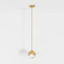 Gold pendant light with spherical glass shade suspended from matching brass canopy against white background.