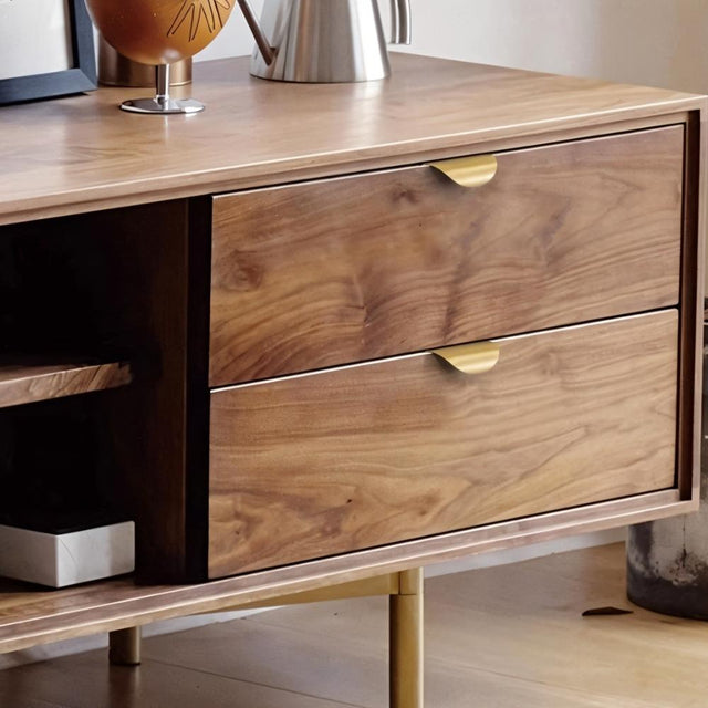 "Gold leaf-shaped drawer pulls on a walnut wood dresser in a living room."