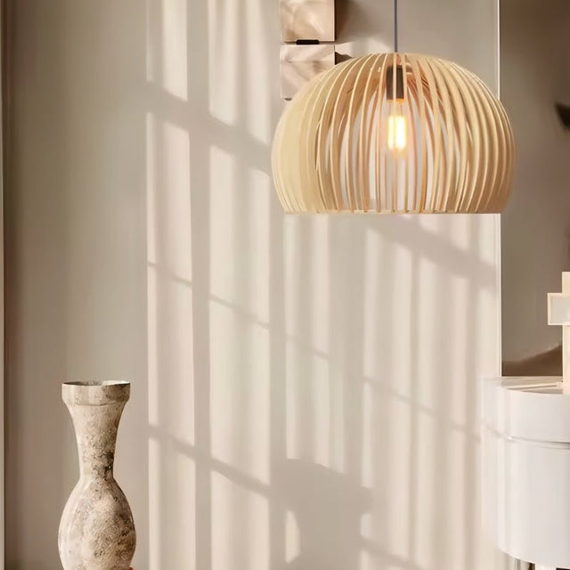 "Wooden pendant light with slatted dome design, casting beautiful shadows, crafted from natural wood to enhance modern and rustic interiors."