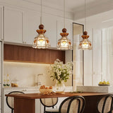 "Three handcrafted pendant lights with heart-patterned stained glass hanging above a kitchen island, creating a focal point."