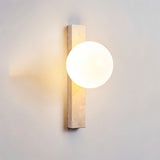 "Elegant travertine wall lamps with frosted glass globes mounted in a contemporary bedroom"