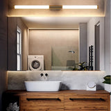 "A modern, linear LED vanity light mounted horizontally above a bathroom mirror with a sink and other bathroom fixtures."
