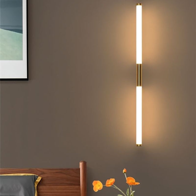 "A modern, linear LED wall lamp mounted vertically on a wall, illuminating a room."