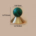 Green and black marbled sphere knob with brass cone base on beige background, 1.2 inches tall.