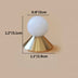 White ceramic ball knob with brass cone base, shown with dimension measurements on beige background.