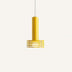 Yellow cylindrical pendant light with horizontal slat shade detail, suspended against neutral background.