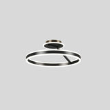 "A modern LED ceiling light with interlocking black rings, shown against a light gray background."