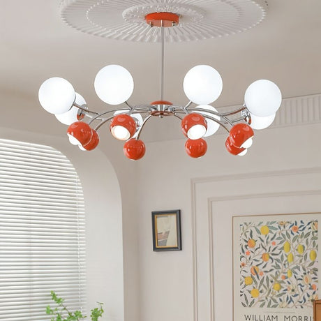 "An 8-light mid-century modern chandelier with red and white acrylic globe diffusers, hanging in a room with artwork and blinds."