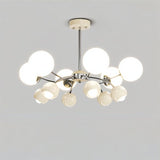 "An 8-light mid-century modern chandelier with white acrylic globe diffusers and a chrome frame, against a light gray background."