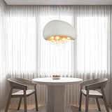 "pendant light with resin dome and illuminated globes, hanging above a modern dining table setup, warm ambiance"