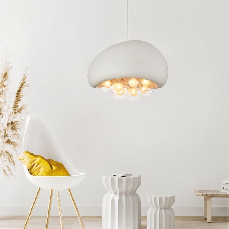 "white resin dome pendant light with glowing globes, modern minimalist decor, accent chair, and neutral tones"