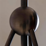 "Close-up of a modern metal pendant light with a central sphere detail."