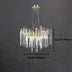 Round chandelier with a gold finish and icicle-like glass pendant accents, measuring 23.62" wide by 15.74" high.