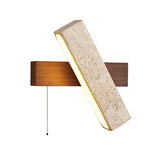 "A modern wall lamp with an angled yellow travertine shade and a walnut rectangular base, isolated on a white background, showcasing its unique design and natural materials."
