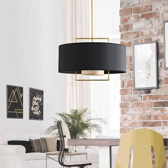 "A black pendant light with a gold frame in a living room with white furniture."