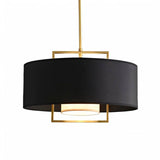 "Close-up of the black fabric shade and gold frame of a pendant light."