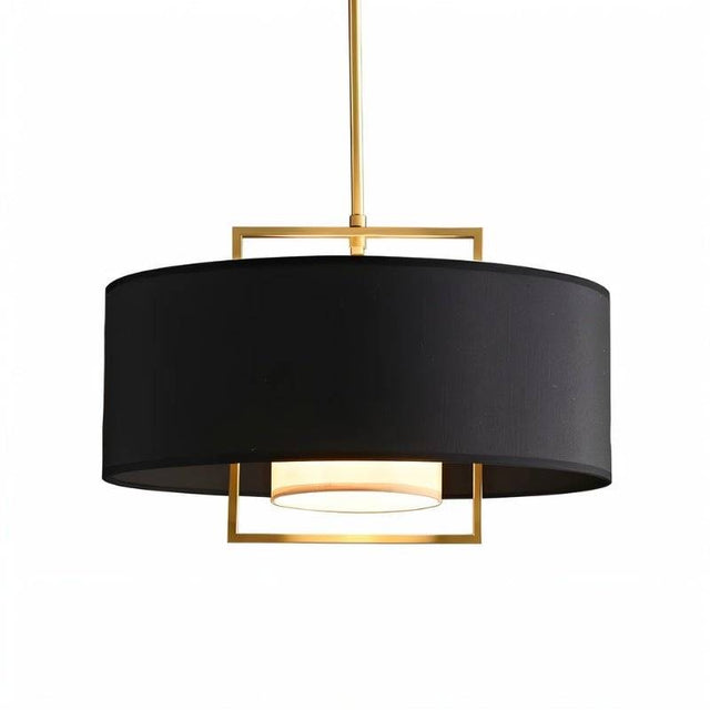 "Close-up of the black fabric shade and gold frame of a pendant light."