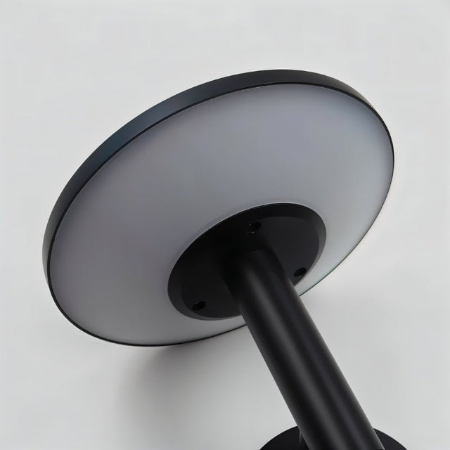 "Close-up of the diffuser of a modern, circular outdoor wall lamp, showing its sleek design."