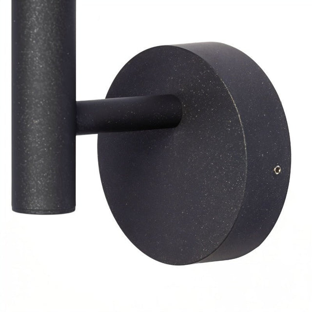 "Close-up of the motion sensor on a modern, circular outdoor wall lamp."