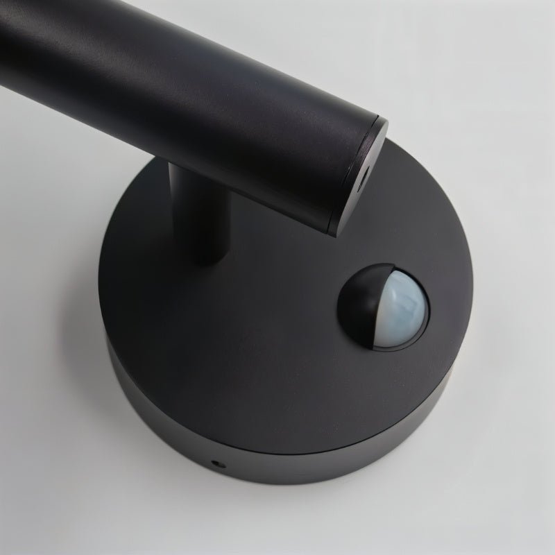 "Close-up of the motion sensor on a sleek, modern outdoor wall lamp."