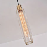 "Close-up of a modern pendant light with an elongated, faceted crystal shade and brass frame, showcasing its intricate design and captivating light refraction."