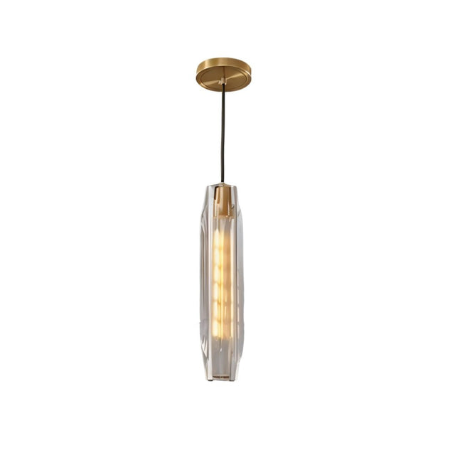 "Modern pendant light with an elongated, faceted crystal shade and brass frame, isolated on a white background."