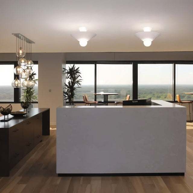 "The Glome Ceiling Lamp featuring a modern aluminum design with conical elements and a central globe bulb, installed in a spacious office, offering ambient lighting and stylish decor."