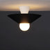 "The Glome Ceiling Lamp in black and white combination, emphasizing its artistic geometric design with a central globe bulb, installed in a dark-themed room for modern elegance."
