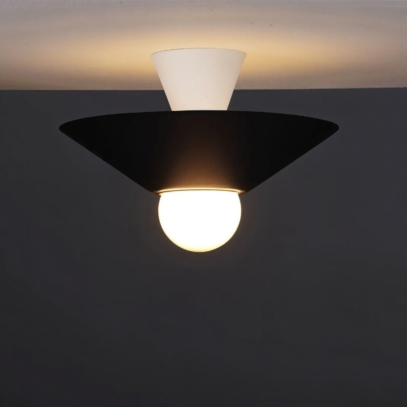 "The Glome Ceiling Lamp in black and white combination, emphasizing its artistic geometric design with a central globe bulb, installed in a dark-themed room for modern elegance."