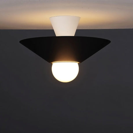 "The Glome Ceiling Lamp in black and white combination, emphasizing its artistic geometric design with a central globe bulb, installed in a dark-themed room for modern elegance."