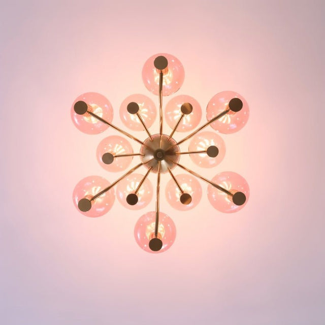 Top view of Gloral Chandelier showing symmetrical pink glass globes and gold arms, ideal for modern indoor lighting design.