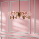Gloral Chandelier with pink glass globes and gold metal frame, ideal for luxury living room or bedroom ambient lighting.