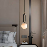 Gong Alabaster Pendant Light - Elegant Design installed beside a bed, adding soft ambient lighting and modern charm to a bedroom setting.