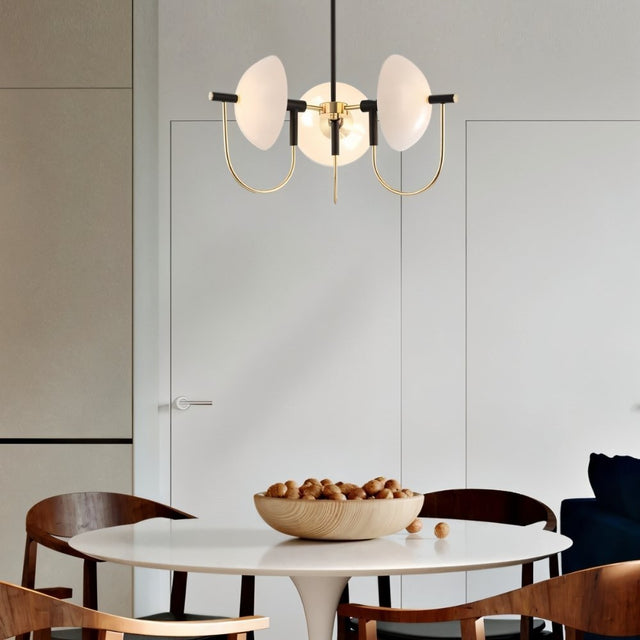"Modern gold three-light chandelier with frosted glass orbs over a dining table."