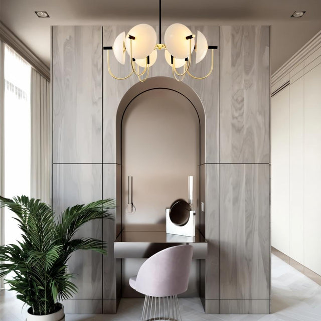 "Modern gold six-light chandelier with frosted glass orbs hanging over a vanity."