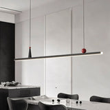 "Modern linear pendant light with black frame and small red and white accents."