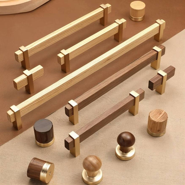 "Assortment of modern knobs and pull bars featuring sleek wooden handles with golden metallic brackets, showcasing various shapes and wood tones."