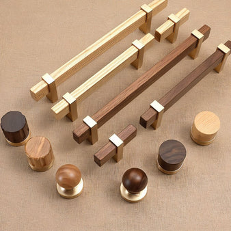 "Collection of modern knobs and pull bars featuring sleek wooden handles with gold metallic brackets in various styles and wood finishes."