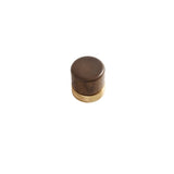 "Close-up of a modern knob featuring a wooden top and a golden metallic base."