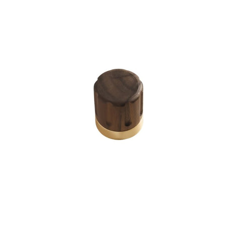 "A modern cylindrical knob featuring a wooden top and a golden metallic base."