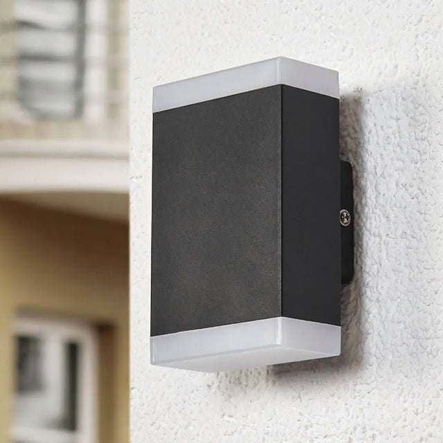 "Helor wall lamp designed for outdoor use, combining style and functionality with dual light emission for a welcoming ambiance on patios and balconies."