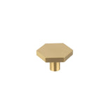"Modern brass hexagon knob with a cylindrical mount, isolated on a white background."