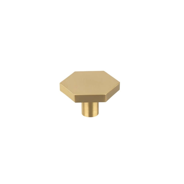 "Modern brass hexagon knob with a cylindrical mount, isolated on a white background."