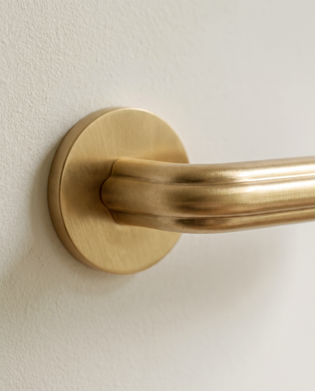 Gatsby Door Handle in Satin Brass, on a plain background