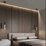  "Pair of modern pendant lights with crystal diffusers and metal frames in a bedroom with wood paneling."