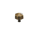 "Angled view of a bronze brass hexagonal knob, isolated on a white background."