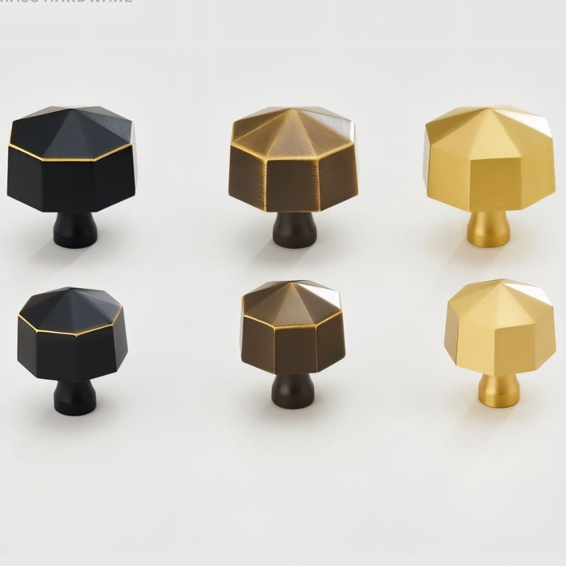 "Set of six hexagonal brass knobs in black, bronze, and gold on a light surface."