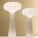 "Sculptural floor lamps with flared tops and subtle ridges, designed in a modern minimalist style, featuring a streamlined silhouette, crafted from high-quality materials."