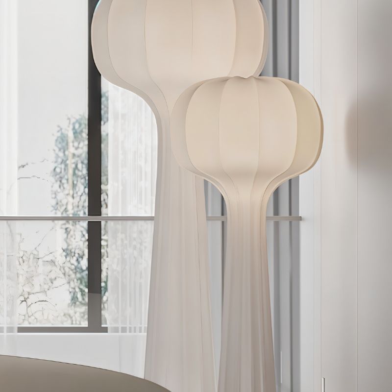 "Sculptural floor lamps with flared tops and streamlined silhouettes, placed in a bright interior with natural light, designed with minimalist style and high-quality material."