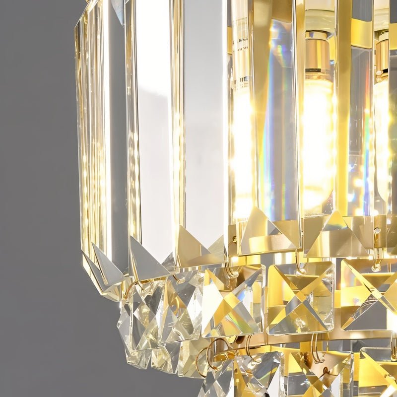 "Close-up of a tiered crystal pendant light with a brass frame, showing the intricate details of the crystal elements and their light refraction."